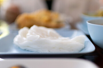 Delicate rice noodle on a blue plate.