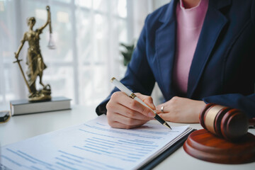 Lawyer reviewing and signing business contract or legal document