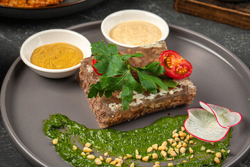 Portion of russian meat jelly dish kholodetz with sauces