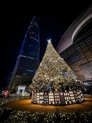 Christmas pine tree near Lotte World Tower. Seoul city, South Korea.