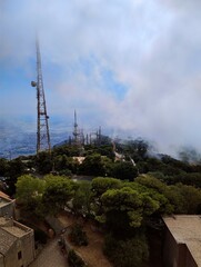 Foggy cablecar in Erice on a hill. Sicilian tourism. Tower view over Sicily. Italian life. Beautiful summer day. Cloudy weather. Hill in the sky. Antenna. Countryside.