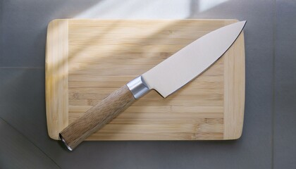 A sharp kitchen knife resting on a wooden cutting board, perfect for culinary tasks and food preparation.