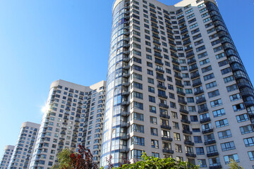 the facade of the new building against the blue sky, office buildings