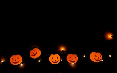 Orange pumpkin lights glowing in the dark, creating a festive Halloween atmosphere. 
