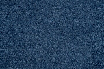 Textured blue cotton chambray denim fabric, showcasing its weave and color variations.