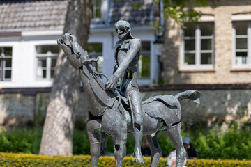 Obraz premium One of bronze statues show the Biblical Four Horsemen of the Apocalypse, Bruges, Belgium