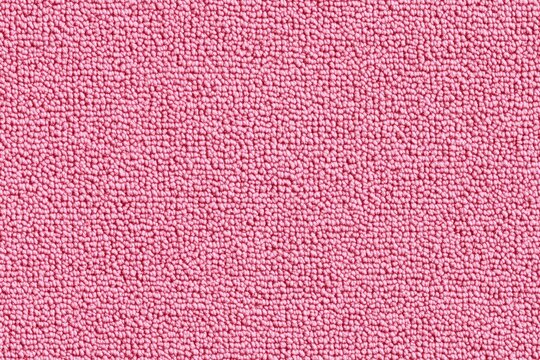 Textured pink cotton chenille fabric, showcasing a soft and fuzzy surface with a uniform pattern. Ideal for backgrounds or textile design.