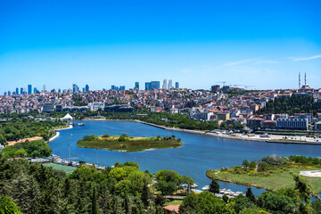 Türkiye. Istanbul. Panoramic view of the Golden Horn with its green banks, buildings and skyscrapers in the background under a sunny blue sky