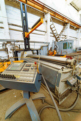 Industrial machinery arranged for metal processing workshop. A metal workshop showcases advanced machinery and controls, emphasizing efficiency and innovation in the industry.