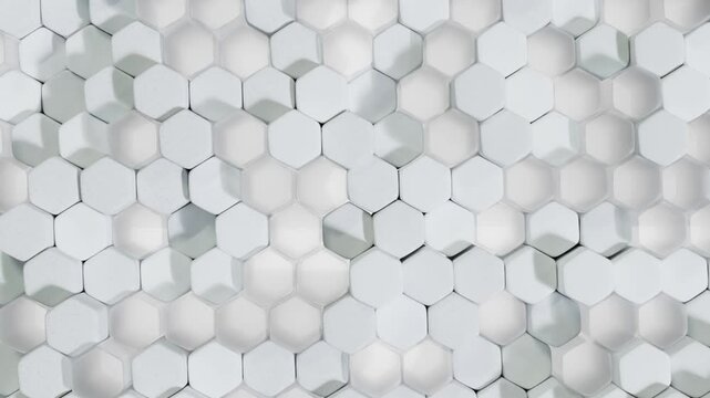 Abstract white background made of hexagons. Seamless looping animation. Dynamic background with hexagons separated by height. In a modern 3D style.
