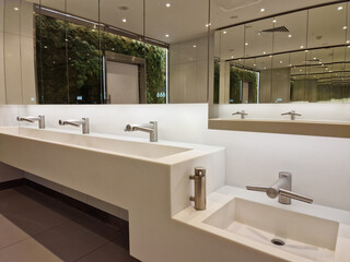 Wroclaw, Poland  03 07 2024: modern interior design in public bathroom. tap and hand dryer in one