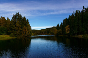 Stunning views of a beautiful sunset or sunrise over a pond or lake in spring or early summer in the evening. Reflecting water.