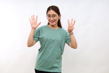 Smiling happy good-looking asian girl giving advice, showing eight fingers as explain rules, make point, standing white background