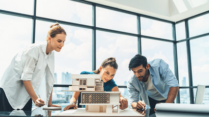 Professional diverse architect engineer team working together to design house model. Group of successful business team discussing and brainstorming about house structure. Civil engineering. Tracery.