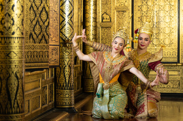 Pantomime (Khon) is traditional Thai classic masked play enacting scenes from the Ramayana with a backdrop of Thai paintings in a public place at Wat Phra Khao, Ayutthaya province, Thailand