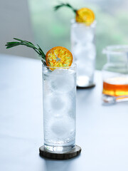 cocktail with candied orange and rosemary garnish