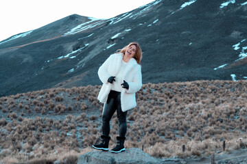 woman dressed in white in winter scenery while laughing