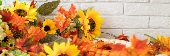 banner with bright autumn background. fall card with yellow sunflowers, orange and red leaves. soft focus