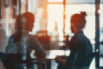 Teaming up to push through towards great success Defocused shot of two businesspeople having a discussion in an office