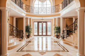 A luxurious mansion interior featuring grand foyer with elegant marble flooring, intricate railings, and lush greenery. spacious design exudes sophistication and warmth