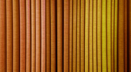 colorful upholstery fabric samples in yellow and brown color tone. close up view of drapery fabric catalog samples. cozy collection of gunny textile fabric swatch samples in earth color tone.