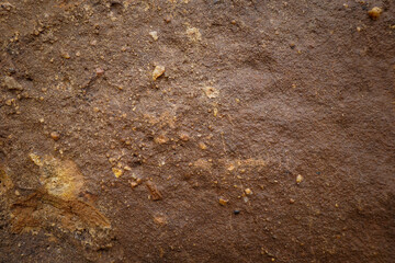 Brown rough sandstone with surface cracks for abstract background and texture for interior or exterior design. Beautiful patterns, space for work, banner, wallpaper close up.