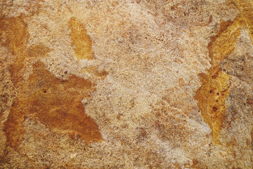 Brown rough sandstone wall with peeling of layer stone surface cracks for abstract background and texture, interior or exterior design. Beautiful patterns, space for work, banner, close up.