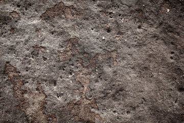 Grey rough sand stone wall with surface pole and potholes for abstract background and texture, interior or exterior design. Beautiful patterns, space for work, banner, wallpaper. Close up.