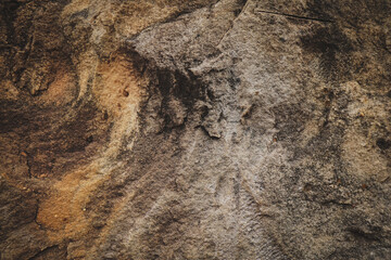 Grey brown rough stone wall for abstract background and texture for interior or exterior design. Beautiful patterns, space for work, banner, wallpaper, close up.