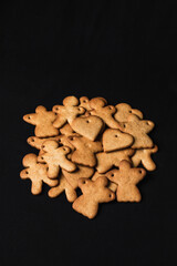 Festive gingerbread cookies on black background