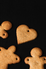 Festive gingerbread cookies on black background