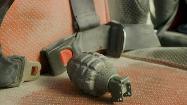 Live grenade bouncing on seat - close up