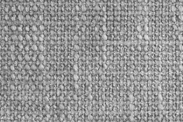 Texture of gray jacquard fabric of rough weave, cloth structure background, close up, macro