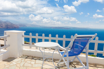relaxing blue chair with table and view of volcano caldera, Santorini, Greece