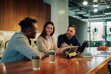 Interracial team of ecology experts working on solar energy implementation