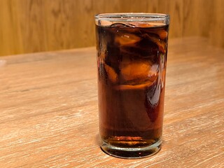 Iced cola soft drink in glass on table in restaurant. Beverage menu