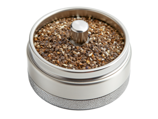 a metal container with a round lid with small brown and black speckled grains