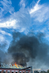 Fototapeta premium A fire is burning on the roof of a building