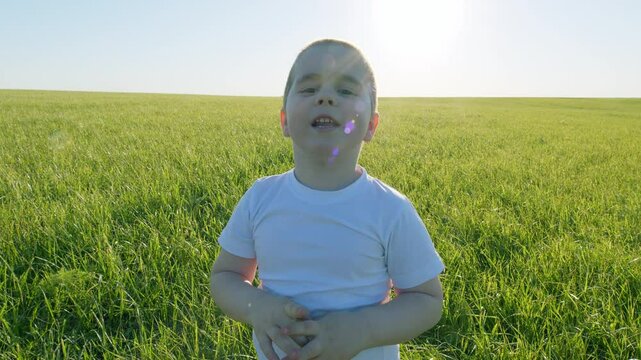Little Child In A White T-Shirt. Portrait Of A Boy Outdoors. Little Boy Engages In Lively Conversation. Cute 5 Year Old Child Caucasian Appearance With White Skin. Steadicam Shot.