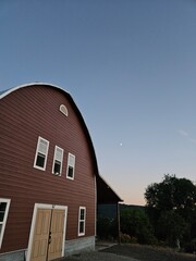 red barn with moon in the background