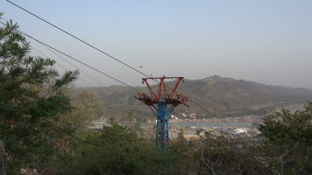 Haridwar, Uttarakhand, India - 10.04.2021 : Rope-way service or Mansa Devi Udankhatola. Mansa Devi Temple, dedicated to goddess Mansa Devi , atop the Bilwa Parvat on the Sivalik Hills, Himalayas.