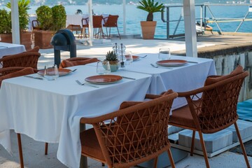 Seaside restaurant with elegant outdoor dining setup