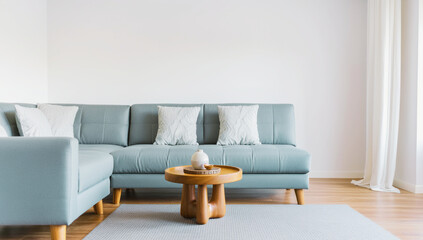 Modern living room with light blue sectional sofa, wooden coffee table, and minimalist decor for a clean, serene space.
