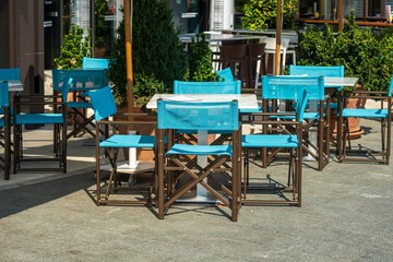 Outdoor cafe seating with bright blue chairs
