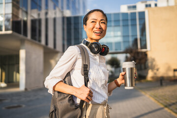 Portrait of mature japanese business woman stand in front company