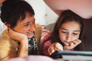 Grandmother and Granddaughter Enjoying Tablet Time
