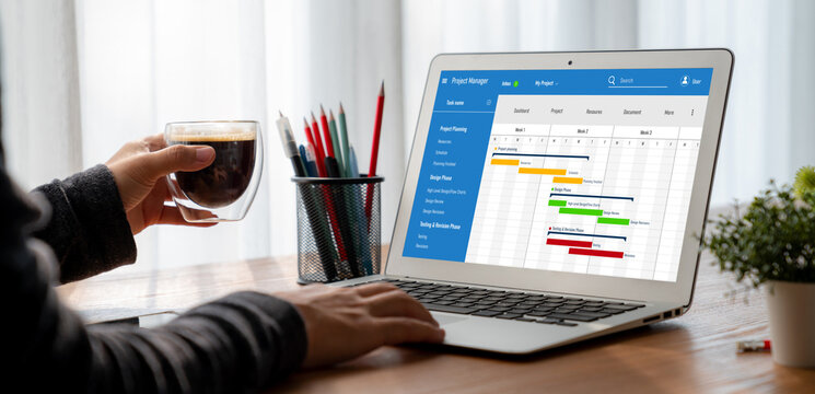 Project planning software for modish business project management on the computer screen showing timeline chart of the team project