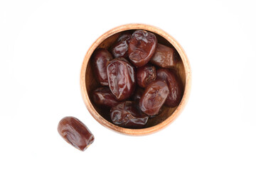 Top view of dehydrated dates fruits in wooden bowl on white background.