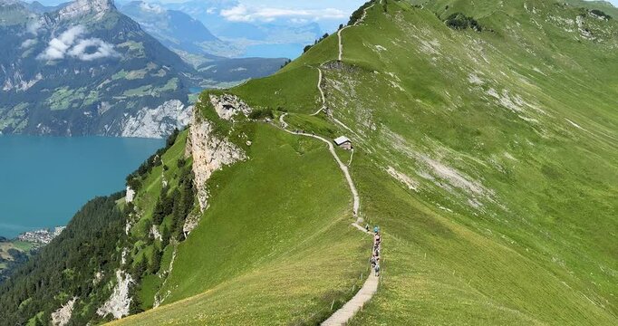 Steep trail of stairs on the Stoos Ridge hike in Switzerland, with Lake Lucerne in the background