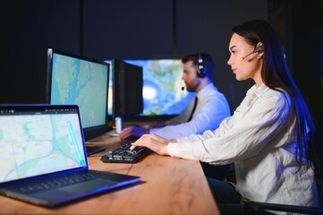 Center of dispatching maintenance. Portrait of cheerful woman and man working via headset...